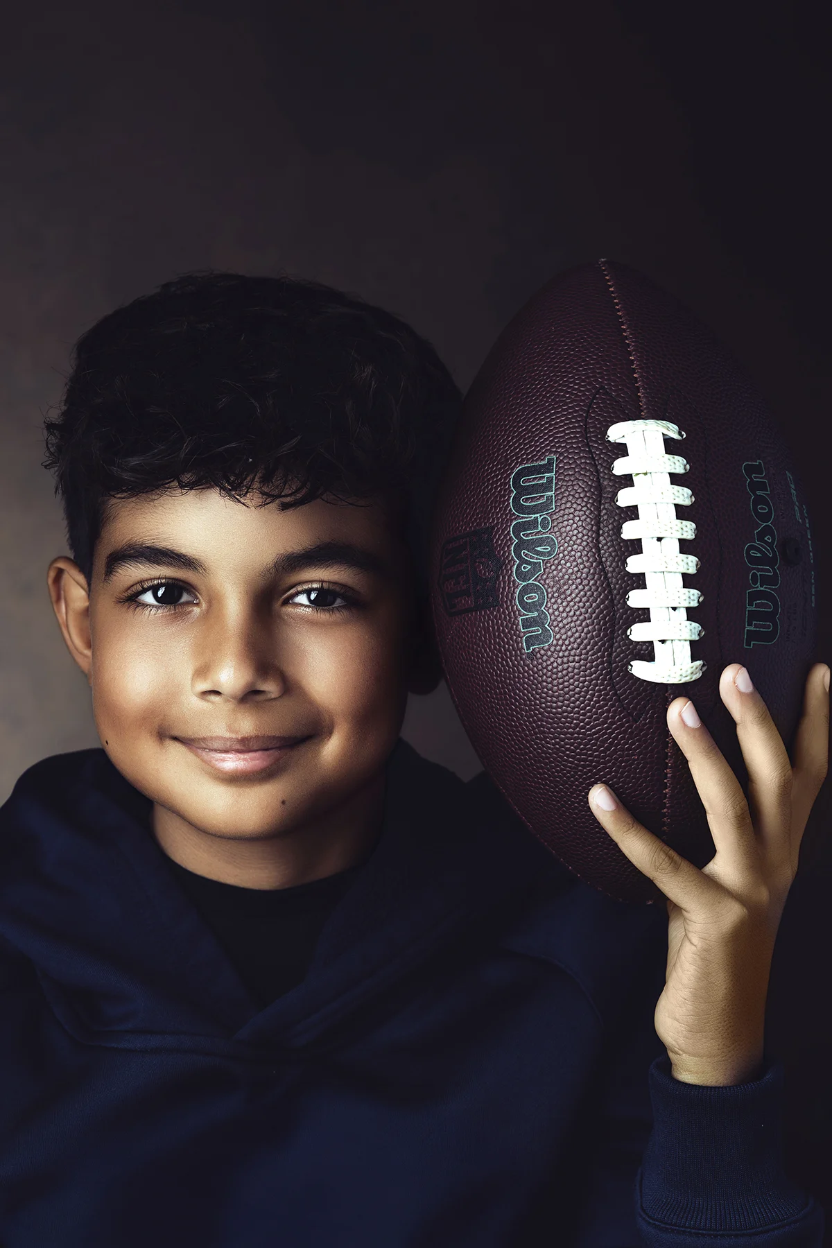 Football player in close-up portrait with dark background