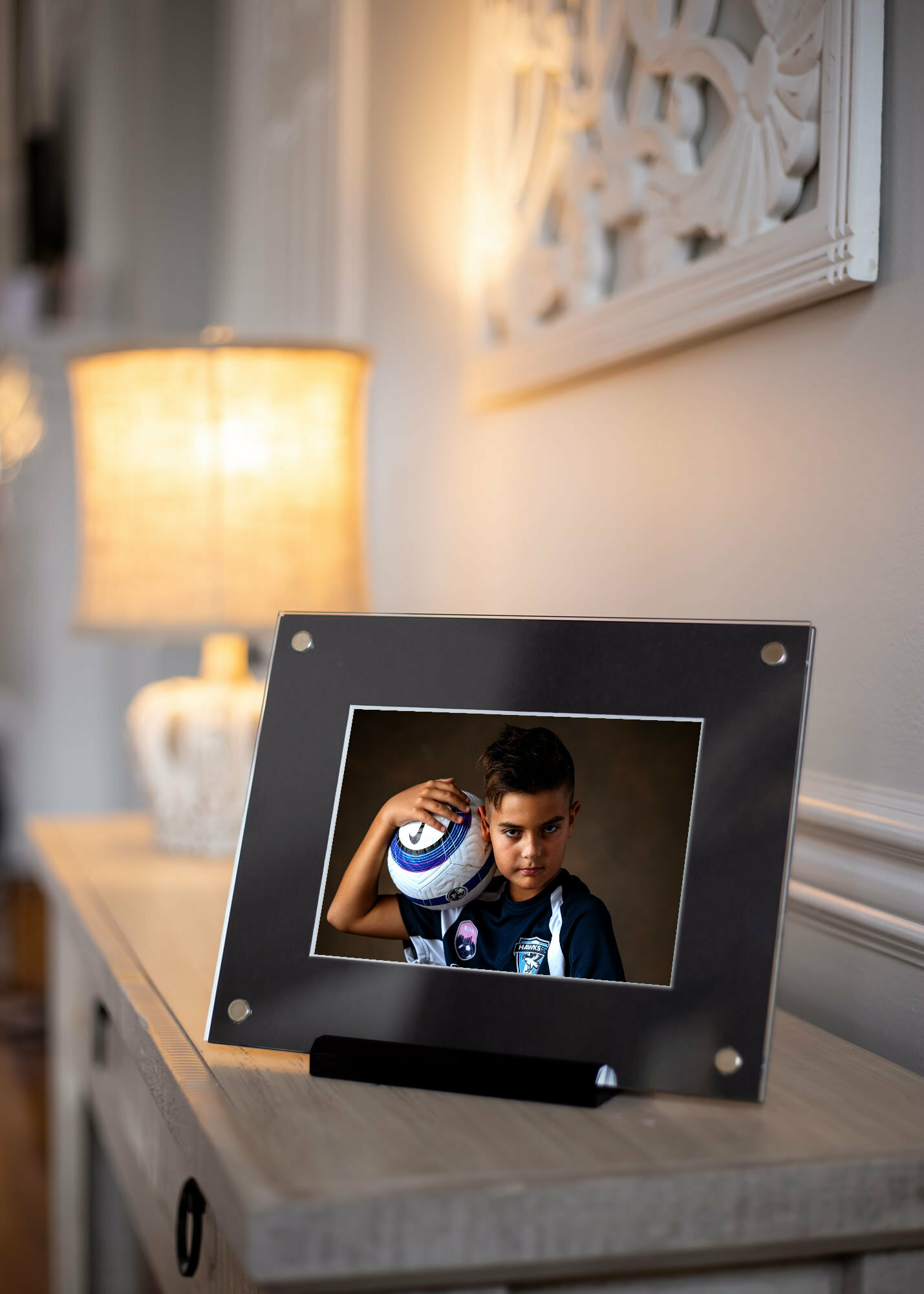 Soccer portrait in acrylic frame displayed on home dresser